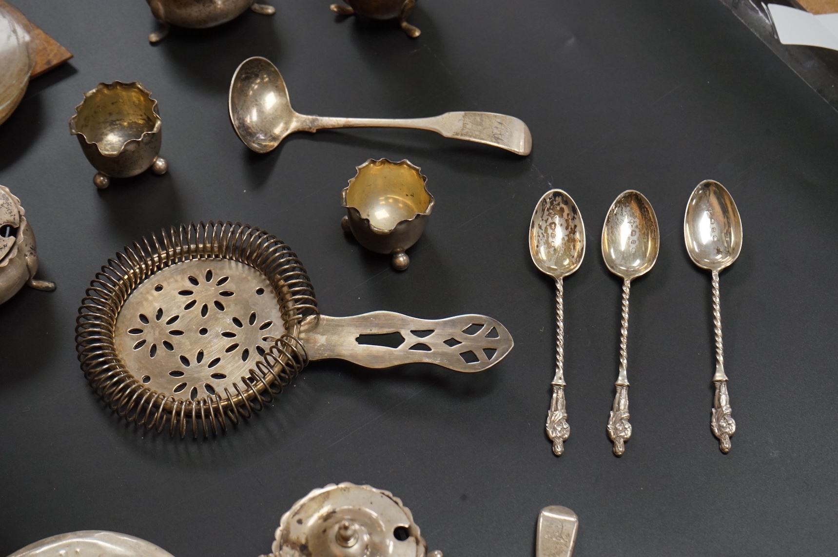 A George V six piece silver condiment set by Mappin & Webb, Birmingham, 1925, two George V silver mounted photograph frames, a small pair of late Victorian silver salts, a silver mounted cut glass dish, a set of six silv